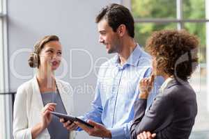 Business executives discussing over digital tablet