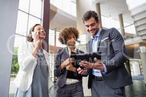 Business executives discussing over digital tablet