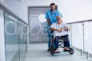 Doctor pushing a patient on wheelchair