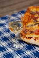 Delicious pizza with a glass of wine