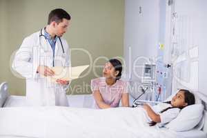 Doctor and nurse interacting with girl patient