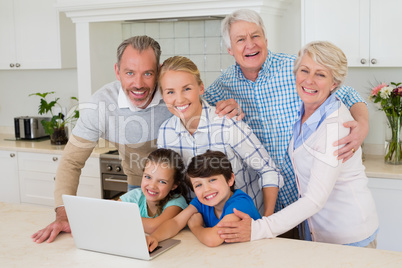 Portrait of happy family standing in kitchen