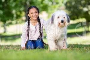Portrait of smiling girl playing with her pet dog