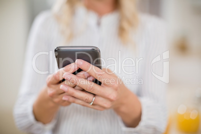 Woman using mobile phone at home