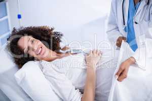 Doctor putting blanket on pregnant woman