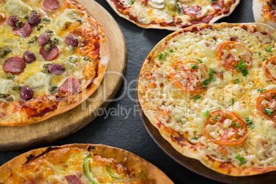 Various pizza arranged on a wooden tray Various pizza arranged on a wooden tray
