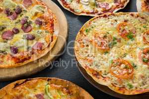 Various pizza arranged on a wooden tray