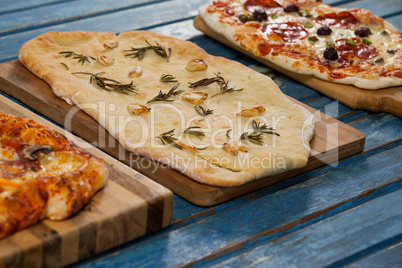 Various delicious italian pizza served on wooden plank