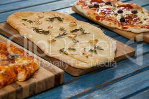Various delicious italian pizza served on wooden plank