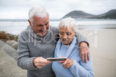 Senior couple using mobile phone