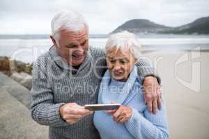 Senior couple using mobile phone