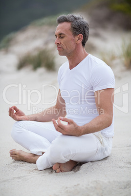 Mature man doing meditation