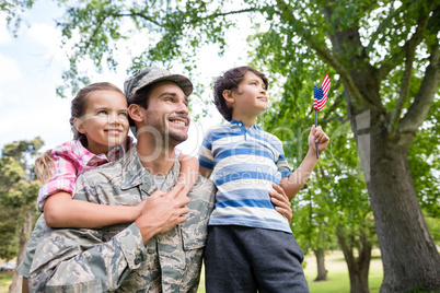 Happy soldier reunited with his son and daughter in park