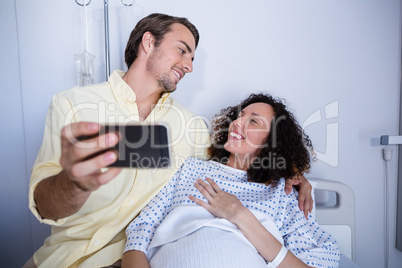 Couple interacting while taking selfie in ward