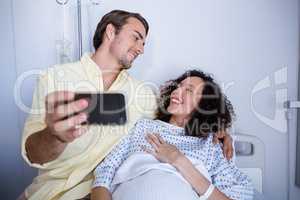 Couple interacting while taking selfie in ward