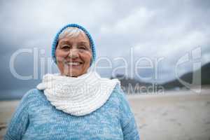 Portrait of senior woman standing on the beach