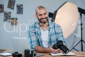 Male photographer reviewing captured photos in his digital camera