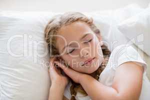 Cute girl sleeping on bed in bedroom