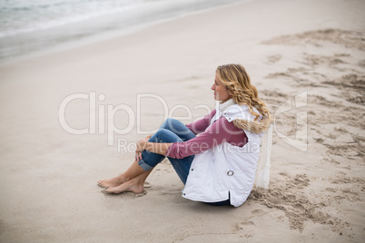 Mature woman sitting on a beach