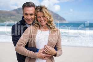 Mature couple embracing each other on the beach