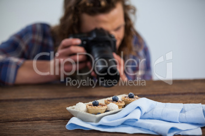 Male photographer photographing food