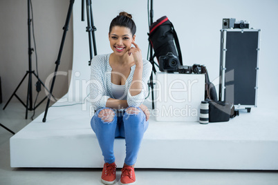 Happy female photographer standing in studio