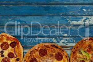 Various delicious italian pizza served on wooden plank