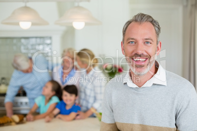 Happy man standing at kitchen