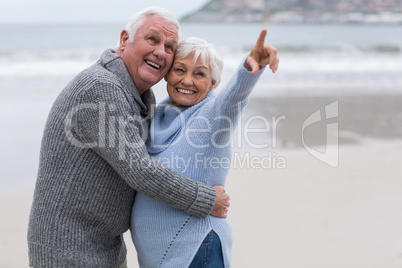 Senior couple standing together on the beach