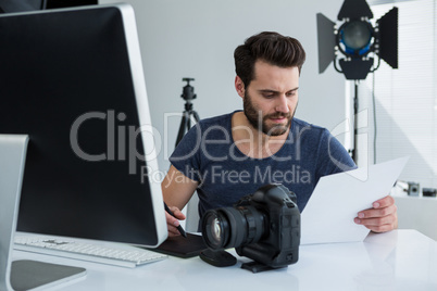 Photographer using graphic tablet at desk