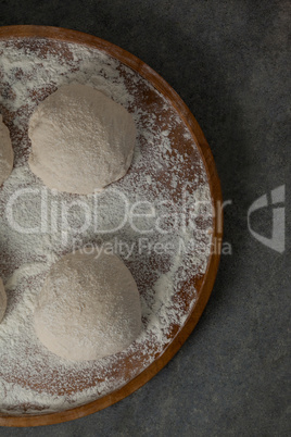 Pizza dough and flour on rolling board