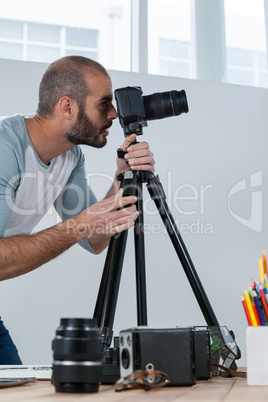 Male photographer working at desk