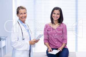 Smiling doctor and patient in clinic