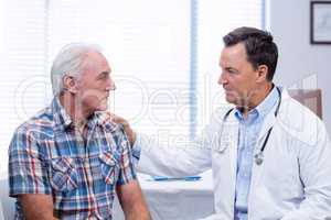 Doctor consoling senior man