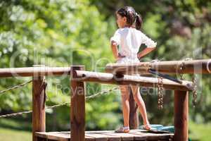Girl standing with hands on hips in park