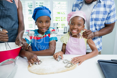 Parents and kids preparing food in kitchen