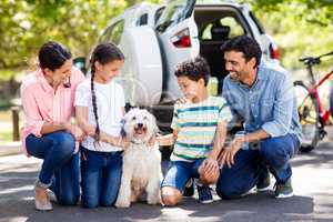 Happy family enjoying together with their pet dog