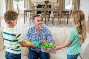 Kids giving surprised gift to their father