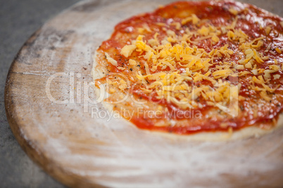 Pizza dough with tomato sauce with grated cheese