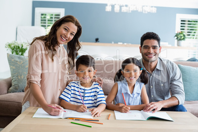 Parents assisting their kids in doing homework at home