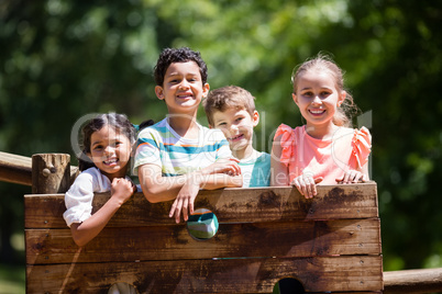 Kids standing on a playground ride in park