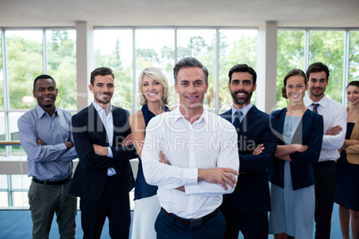 Business executives with arms crossed at conference center