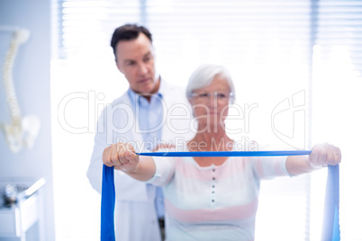 Male physiotherapist giving shoulder massage to senior woman