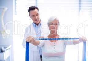Male physiotherapist giving shoulder massage to senior woman