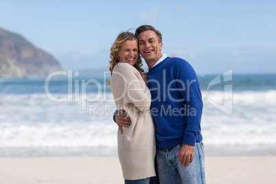 Mature couple embracing each other on the beach