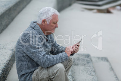 Senior man using mobile phone