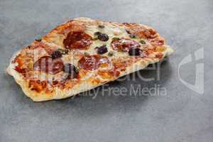 Slice of pizza on grey background