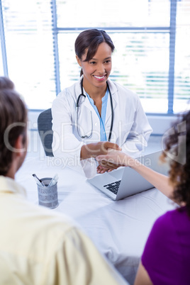 Doctor and woman shaking hands