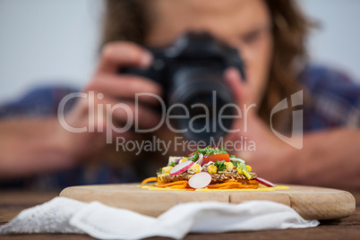 Male photographer photographing food