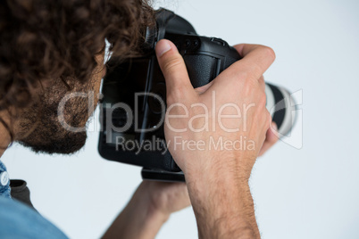 Photographer with digital camera in studio